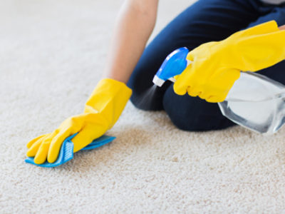 Picture of spraying stain remover on carpet