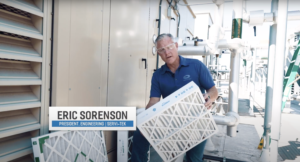 Picture of a technician installating an HVAC air filter